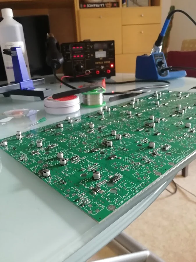 A large assembled printed circuit board on an electronics workbench