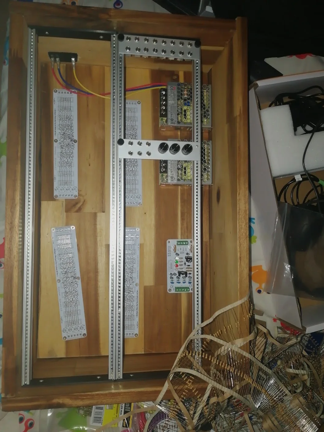 Four mostly unpopulated bus PCBs positioned inside the case, alongside the supplies, a populated supply card, and a few front panels.