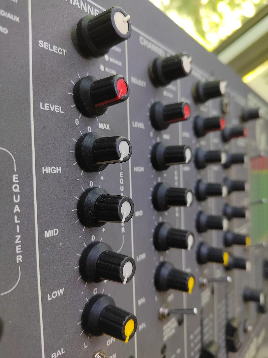 Close-up of the Rodec channel controls: input selector, level, high, mid, low, and balance knobs.