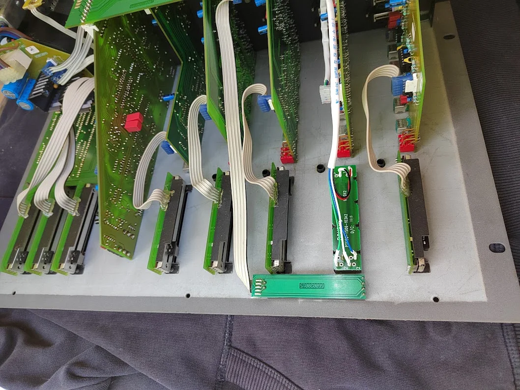 Another view inside the Rodec mixer, with the Bourns fader wiring visible beside the other fader assemblies.