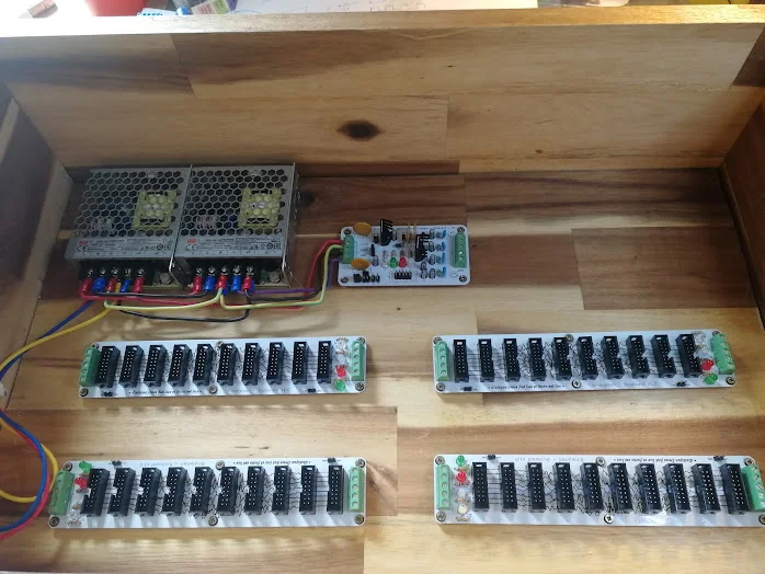 The two Mean Well supplies wired to the supply card, with the four bus boards below awaiting their connections.